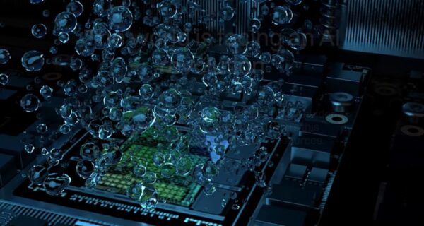Computer chip submerged in liquid with bubbles rising from the surface during data centre cooling.