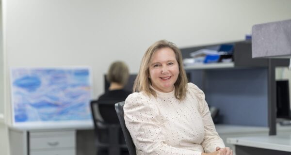 Interflow Chief Financial Officer Tracy Black is seated in an office.